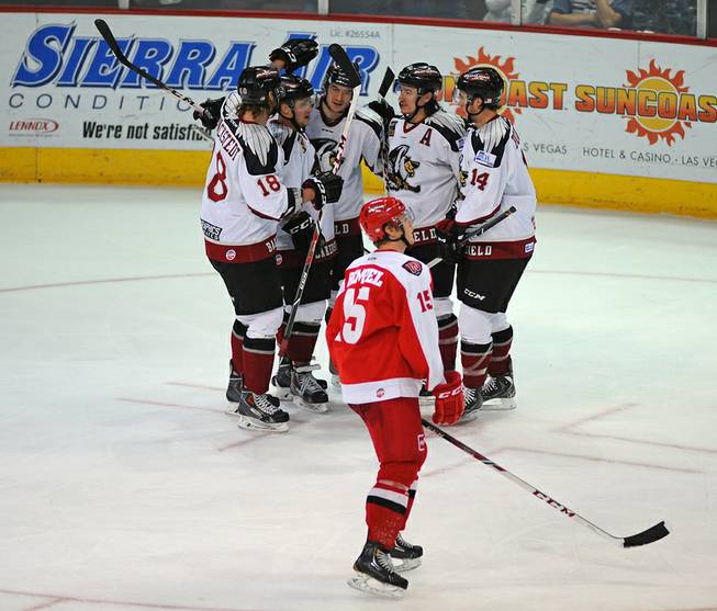 Bakersfield Condors players celebrate a tie-breaking goal scored by Chase Schaeber against the Las Vegas Wranglers late in the third period on Tuesday night.