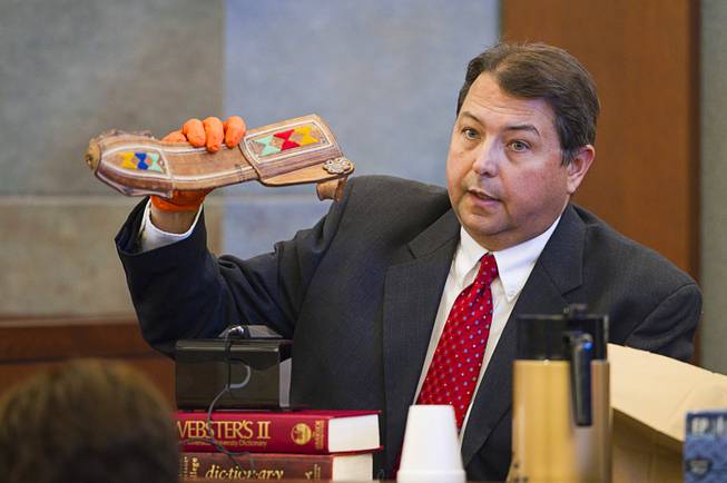 North Las Vegas crime scene analyst Patrick Fischer holds a sheath to a machete during a trial for Armando Vergara-Martinez at the Clark County Regional Justice Center Tuesday, Feb. 25, 2014. Martinez is accused of attacking Maria Gomez with a machete in the parking lot of a North Las Vegas convenience store in 2012.