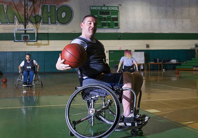 Marc Fenn picks up a rebound during wheelchair basketball practice at Rancho High School Tuesday, Feb. 25, 2014. The team is practicing for a scrimmage against a Wounded Warriors team at Nellis Air Force Base on Thursday.