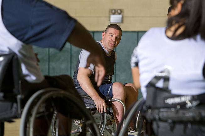 Marc Fenn, center, practices with his wheelchair basketball team at Rancho High School Tuesday, Feb. 25, 2014. The team is practicing for a scrimmage against a Wounded Warriors team at Nellis Air Force Base on Thursday.