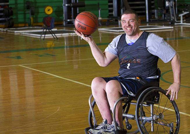Marc Fenn practices with his wheelchair basketball team at Rancho High School Tuesday, Feb. 25, 2014. The team is practicing for a scrimmage against a Wounded Warriors team at Nellis Air Force Base on Thursday.