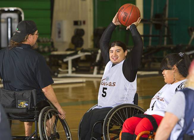 Steven Morales, center, prepares to pass the ball during wheelchair basketball practice at Rancho High School Tuesday, Feb. 25, 2014. The team is practicing for a scrimmage against a Wounded Warriors team at Nellis Air Force Base on Thursday.