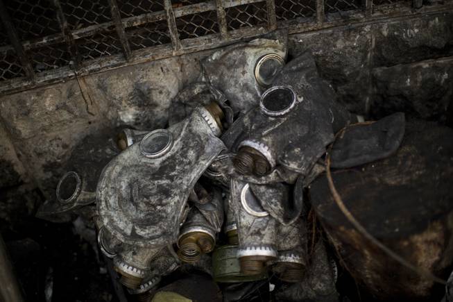 Gas masks from opposition supporters are seen next to a barricade in Kiev's Independence Square, the epicenter of the country's current unrest, Ukraine, Monday, Feb. 24, 2014. 