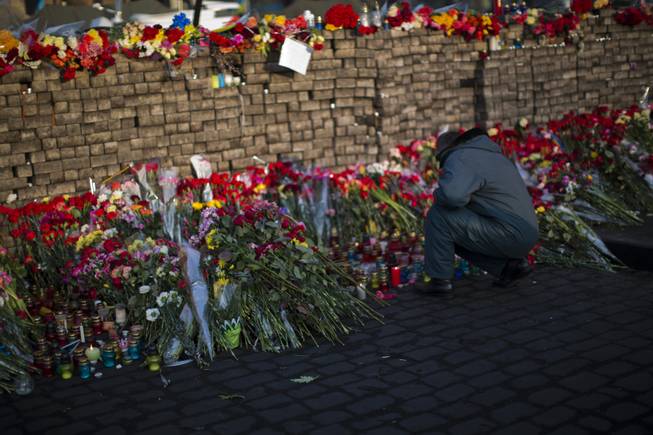 Flowers are seen placed at a barricade in Kiev's Independence Square, the epicenter of the country's current unrest, Ukraine, Monday, Feb. 24, 2014. 