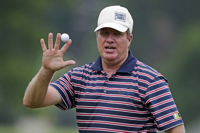 Steve Elkington, of Australia, holds up the ball after a birdie on the 18th hole during the first round of the Senior Players Championship golf tournament at Fox Chapel Golf Club in Pittsburgh, Thursday, June 27, 2013. 