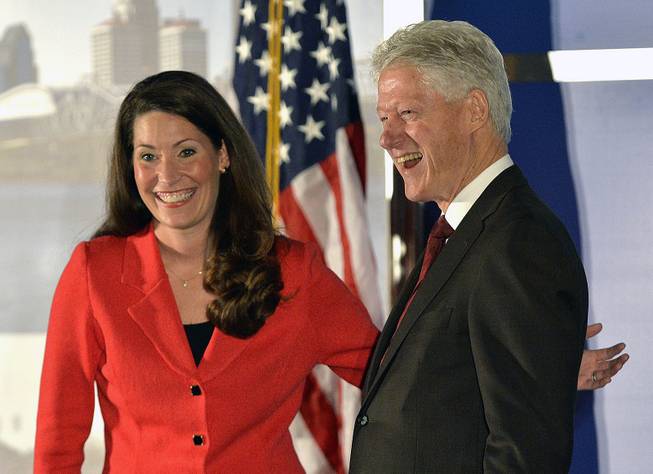 Democratic Senate challenger Alison Lundergan Grimes, left, speaks with former Presidet Bill Clinton as they are introduced at a fundraiser at the Galt House Hotel, Tuesday, Feb. 25, 2014, in Louisville, Ky.