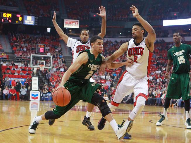 Colorado State guard Daniel Bejarano is defended by UNLV guard Jelan Kendrick, left, and forward Khem Birch during the first half of their Mountain West Conference game Wednesday, Feb. 26, 2014 at the Thomas & Mack Center.