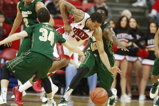 UNLV guard Bryce Dejean Jones dribbles through Colorado State guards David Cohn and Jon De Ciman during their Mountain West Conference game Wednesday, Feb. 26, 2014 at the Thomas & Mack Center. UNLV won 78-70.