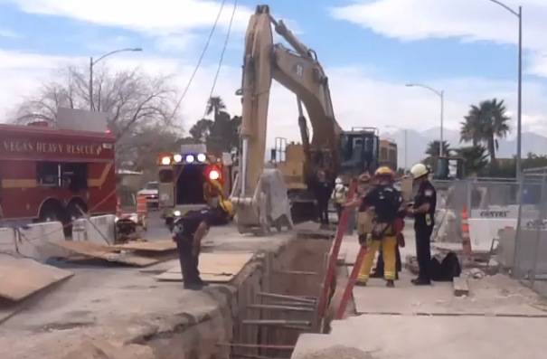 Las Vegas Fire &amp; Rescue crews attempt to rescue a worker who was injured and trapped under a piece of heavy equipment in a 20-foot-deep trench in the 5400 block of Vegas Drive on Wednesday, Feb. 26, 2014.