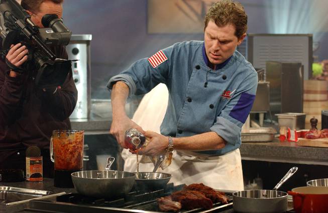 Iron Chef Bobby Flay of Mesa Grill in New York works on the grill during the taping of the "Iron Chef America" in New York, Oct. 13, 2004. 