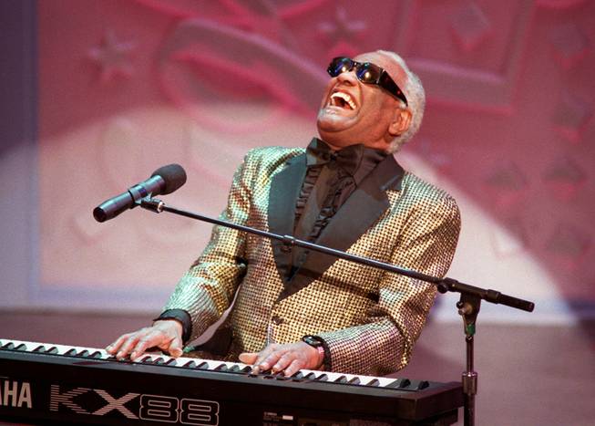 Blues singer Ray Charles sings "Oh What a Beautiful Morning" in this March 3, 1996, file photo in Pasadena, Calif. during the 25th annual Easter Seal fundraiser event. Charles, the Grammy-winning crooner who blended gospel and blues in such crowd-pleasers as ``What'd I Say'' and heartfelt ballads like ``Georgia on My Mind,'' died June 10, 2004. He was 73.  