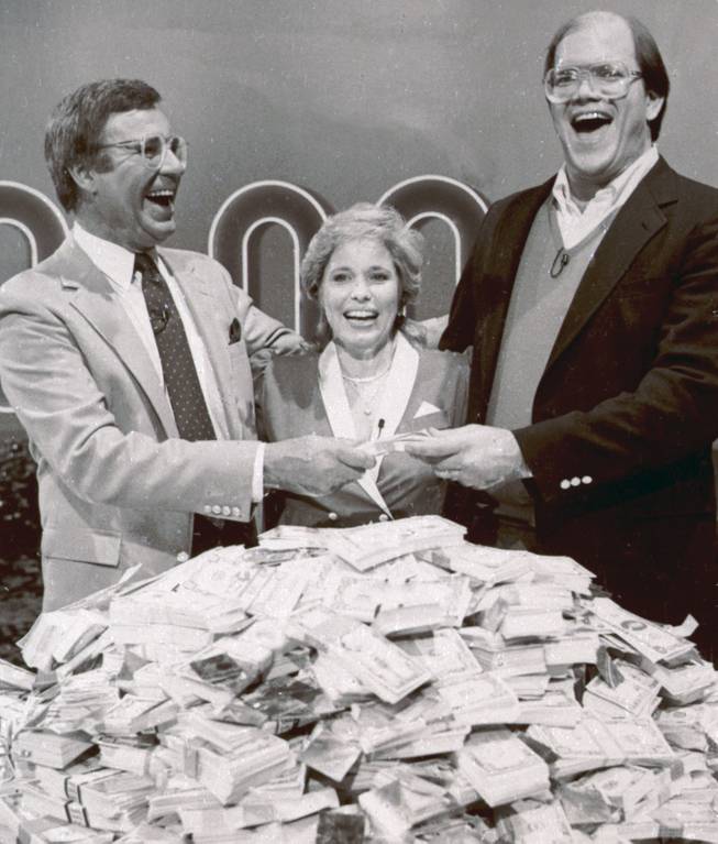 This Jan. 16, 1986, file photo shows host Jim Lange, left, congratulating Connie and Steve Rutenbar of Mission Viejo, Calif., after they won $1 million on the TV show "The $1,000,000 Chance of a Lifetime." Lange, the first host of the popular game show "The Dating Game," has died at his home in Mill Valley, Calif. He was 81.
