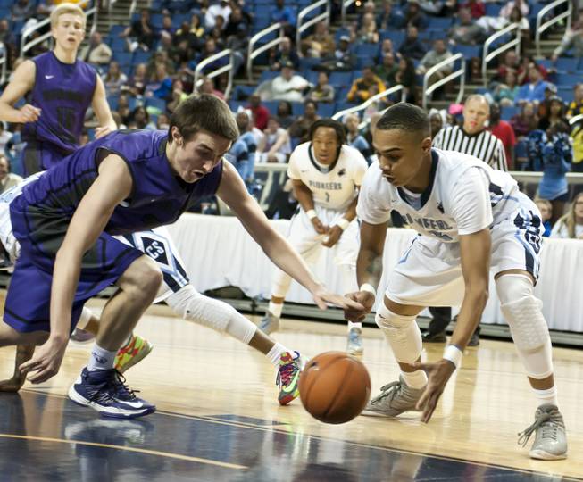 Gerad Davis reaches for the ball against a defender Thursday, Feb. 27, 2014 as Canyon Springs defeats Spanish Springs 66-51 in the semifinals of the Nevada State Championships at Lawlor Events Center in Reno.