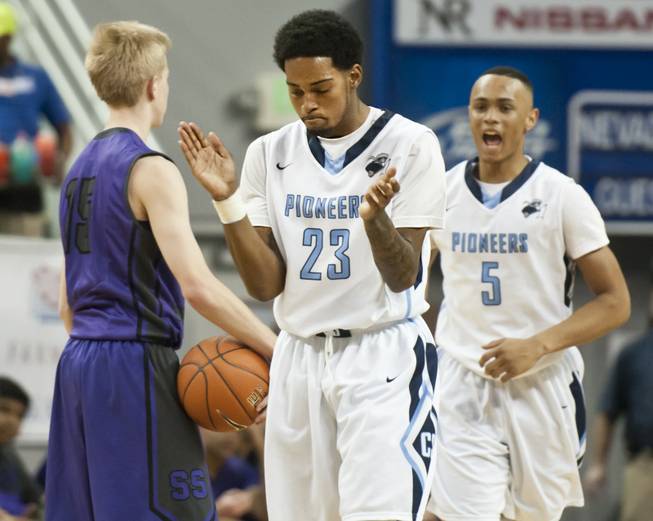 Shaquile Carr, center, celebrates after forcing a traveling call as teammate Gerad Davis approaches from behind in Canyon Springs' victory over Spanish Springs 66-51 in the semifinals of the Nevada State Championships at Lawlor Events Center in Reno, Thursday, Feb. 27, 2014.