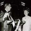 Ralph Griswold, comptroller of the Aladdin Hotel, presents a unique money ribbon that was used in ceremonies marking the opening of the newly built Sinbad Lounge at the Aladdin to Kitty Rodman, first vice president of the Easter Seal Society for Crippled Children, Aug. 12, 1969.