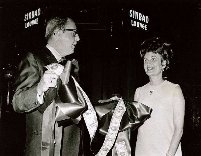Ralph Griswold, comptroller of the Aladdin Hotel, presents a unique money ribbon that was used in ceremonies marking the opening of the newly built Sinbad Lounge at the Aladdin to Kitty Rodman, first vice president of the Easter Seal Society for Crippled Children, Aug. 12, 1969.