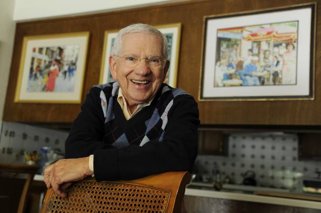 In this Wednesday, Feb. 26, 2014, photo, actor, artist and singer Robert Clary stands near some of his paintings at his home in Beverly Hills, Calif. Clary, who starred in the sitcom “Hogan’s Heroes,” turns 88 on Saturday, March 1, 2014.