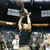 Head coach Chad Beeten raises the NIAA championship trophy overhead Saturday, March 1, 2014 as Clark High School defeated Elko High School 43-25 winning the Division I-A state championship at Lawlor Event Center in Reno.