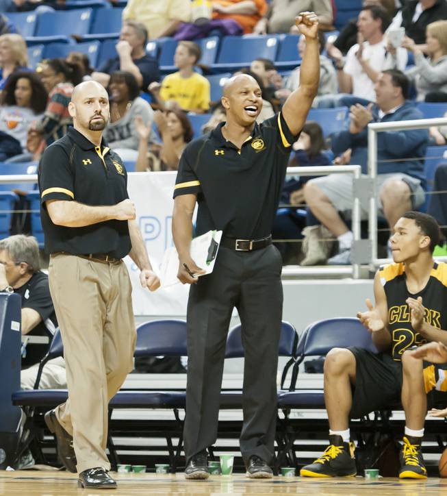 After getting a call on defense, head coach Chad Beeten, left, pumps his fist downward as an assistant coach raises his high Saturday, March 1, 2014 as Clark High School defeated Elko High School 43-25 winning the Division I-A state championship at Lawlor Event Center in Reno.