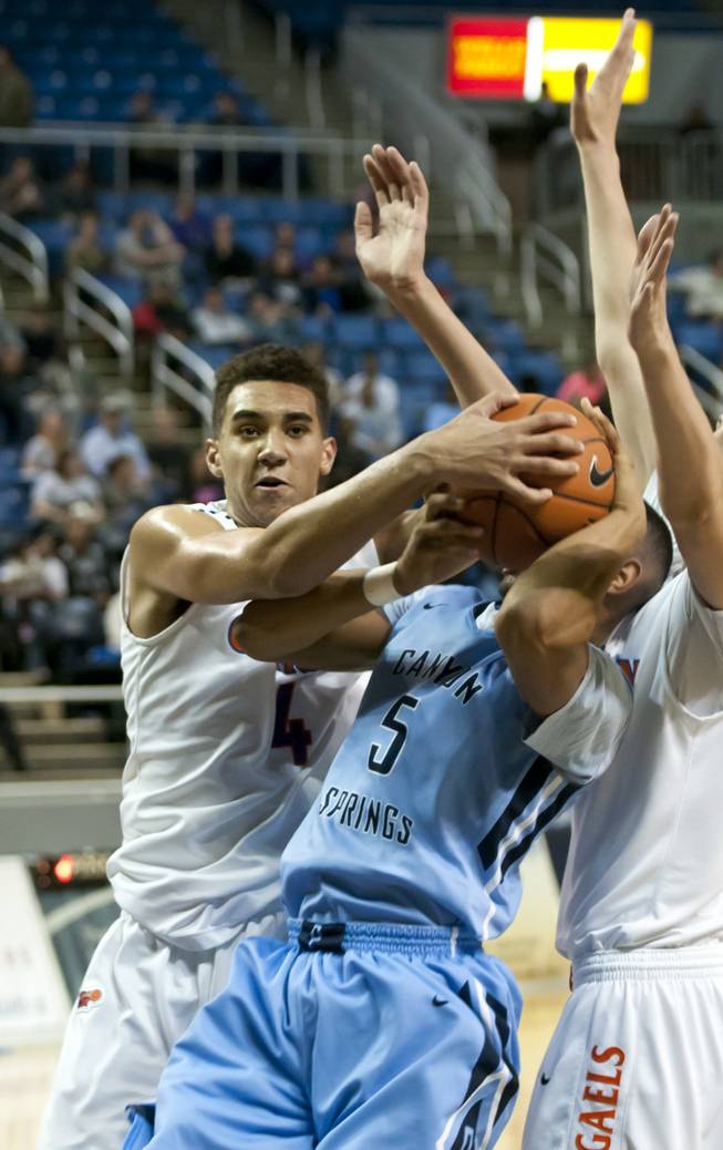 Chase Jeter, right, gets his hand on the ball forcing a jump ball Friday, Feb. 28, 2014 as Bishop Gorman defeated Canyon Springs 71-58 in the Nevada state championship game at Lawlor Event Center in Reno.
