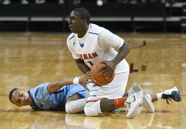 Obim Okeke, right, forces the ball away from an opponent before feeding another teammate for a fastbreak Friday, Feb. 28, 2014 as Bishop Gorman defeated Canyon Springs 71-58 in the Nevada state championship game at Lawlor Event Center in Reno.