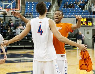 Bishop Gorman teammates celebrate after the final buzzer Friday, Feb. 28, 2014 as Bishop Gorman defeated Canyon Springs 71-58 in the Nevada state championship game at Lawlor Event Center in Reno.