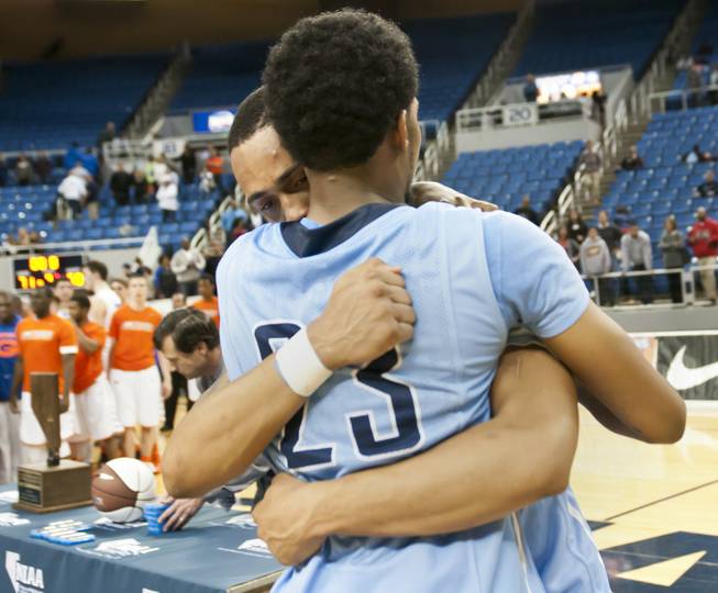 Canyon Springs teammates share a tearful hug Friday, Feb. 28, 2014 as Bishop Gorman defeated Canyon Springs 71-58 in the Nevada state championship game at Lawlor Event Center in Reno.