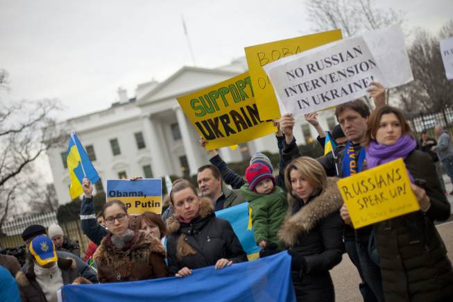 Demonstrators gather outside the White House in Washington on Saturday, Feb. 1, 2014. Russian troops took over Crimea as the parliament in Moscow gave President Vladimir Putin a green light Saturday to use the military to protect Russian interests in Ukraine.