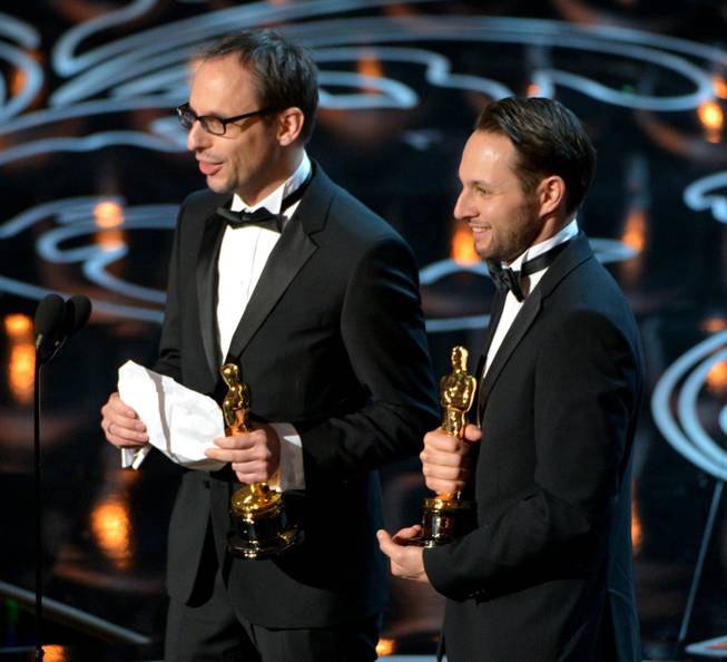 Laurent Witz, left, and Alexandre Espigares accept the award for best animated short film of the year for "Mr. Hublot" during the Oscars at the Dolby Theatre on Sunday, March 2, 2014, in Los Angeles.  (Photo by John Shearer/Invision/AP)