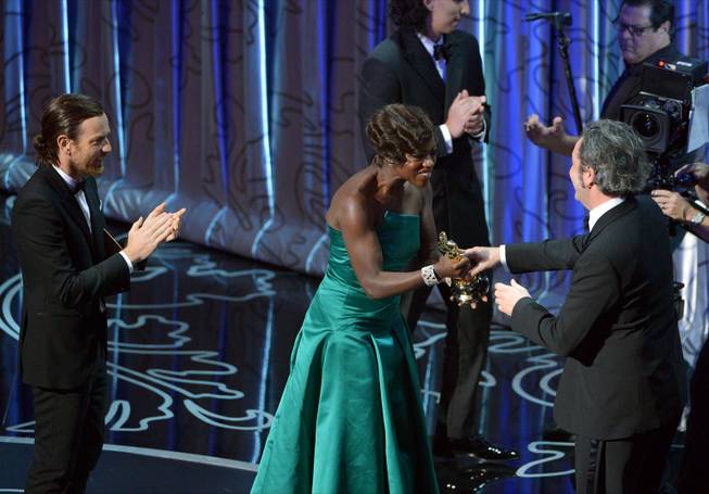 Presenters Ewan McGregor, left, and Viola Davis present Paolo Sorrentino with the award for best foreign language film of the year for &quot;The Great Beauty&quot; during the Oscars at the Dolby Theatre on Sunday, March 2, 2014, in Los Angeles.  (Photo by John Shearer/Invision/AP)