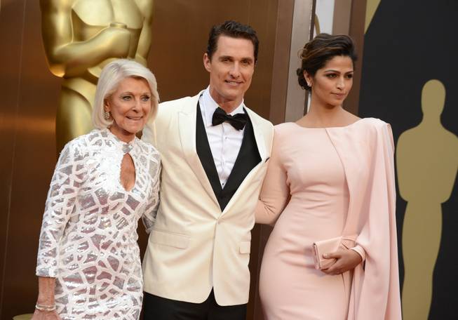 From left, Mary Kathlene McCabe, Matthew McConaughey and Camila Alves arrive at the Oscars on Sunday, March 2, 2014, at the Dolby Theatre in Los Angeles.  (Photo by Jordan Strauss/Invision/AP)