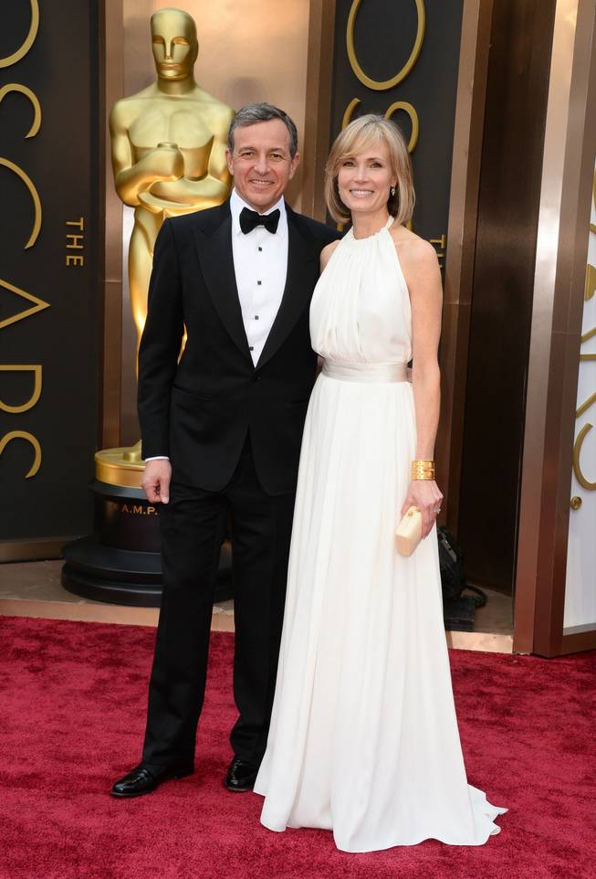 Bob Iger, left, and Willow Bay arrive at the Oscars on Sunday, March 2, 2014, at the Dolby Theatre in Los Angeles.  (Photo by Jordan Strauss/Invision/AP)
