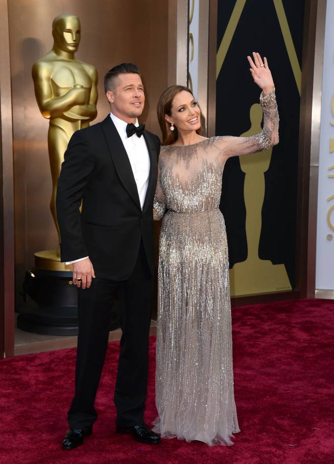 Brad Pitt and Angelina Jolie arrive at the Oscars on Sunday, March 2, 2014, at the Dolby Theater in Los Angeles.