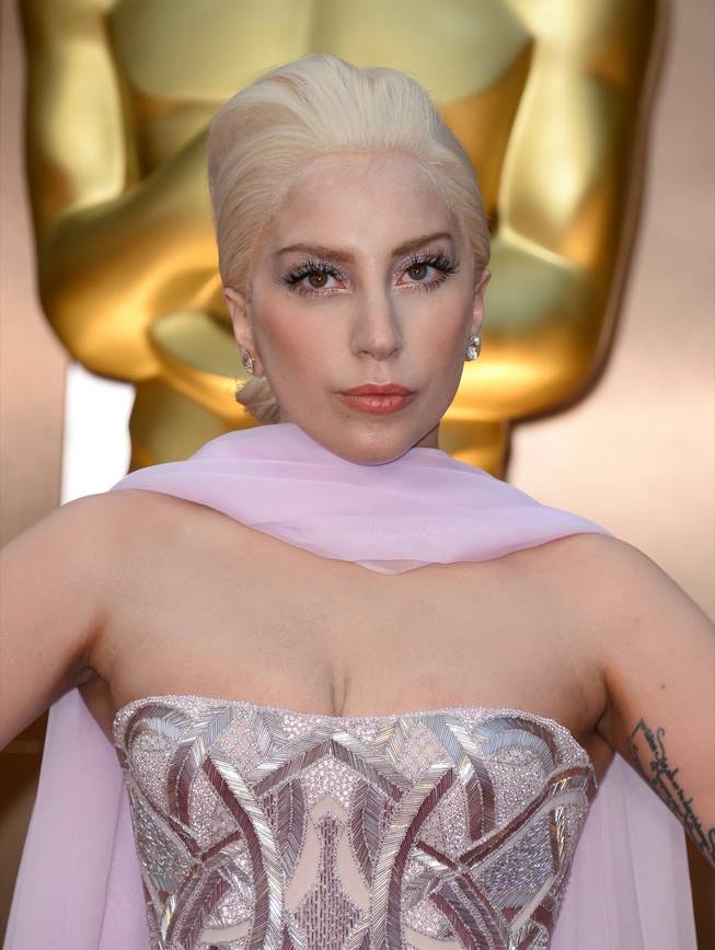 Lady Gaga arrives at the Oscars on Sunday, March 2, 2014, at the Dolby Theater in Los Angeles. 