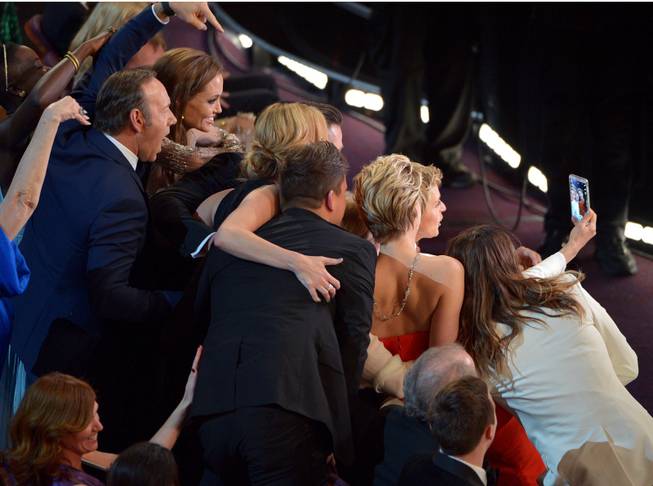 Kevin Spacey, from left, Angelina Jolie, Julia Roberts, Brad Pitt, Jennifer Lawrence, Ellen Degeneres and Jared Leto join other celebrities for a "selfie" during the Oscars at the Dolby Theatre on Sunday, March 2, 2014, in Los Angeles.  (Photo by John Shearer/Invision/AP)