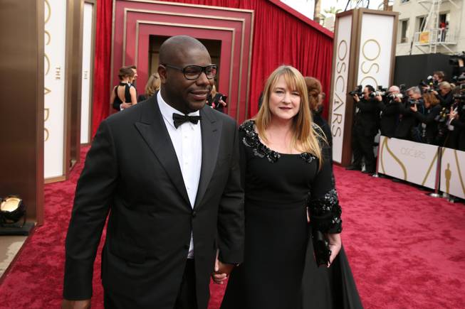 Steve McQueen, left, and Bianca Stigter arrive at the Oscars on Sunday, March 2, 2014, at the Dolby Theatre in Los Angeles.  (Photo by Matt Sayles/Invision/AP)