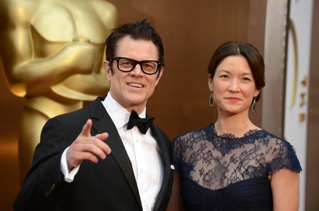 Johnny Knoxville, left, and Naomi Nelson arrive at the Oscars on Sunday, March 2, 2014, at the Dolby Theatre in Los Angeles.  (Photo by Jordan Strauss/Invision/AP)
