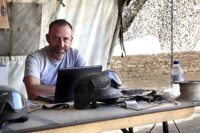 In this photo released by Spanish newspaper El Periodico de Catalunya on Sunday, March 2, 2014, journalist Marc Marginedas, who works for the newspaper, sits by his laptop at the Canadian base in Nakhonay, Afganistan, in this photo taken on Oct. 10, 2010. Marginedas, who was kidnapped by al-Qaida-linked militants in Syria crossed the border into Turkey on Sunday, March 2, 2014, his newspaper reported, as activists said government airstrikes killed at least 13 people in a northwestern border town. Veteran war correspondent Marginedas was abducted on Sept. 4 near Hama by jihadists belonging to the Islamic State of Iraq and the Levant, a breakaway al-Qaida group. He was "moved repeatedly" while in captivity and was accused of spying for the West before his release, his newspaper El Periodico said.