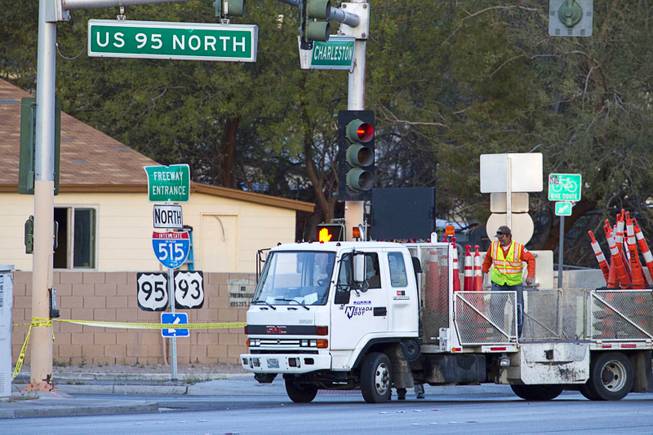 An Nevada of Transportation truck drops off traffic cones near the scene of an officer-involved shooting by Charleston Boulevard and Highway 95 Monday, March 3, 2014.