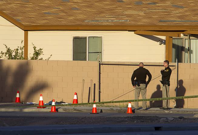 Metro Police officers stand by at the scene of an officer-involved shooting near Charleston Boulevard and U.S. 95, Monday, March 3, 2014. 