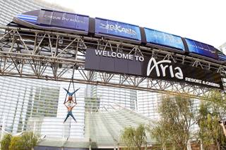 British twin brothers Andrew and Kevin Atherton, Cirque du Soleil aerialists with “Zarkana,” perform under the monorail truss in Aria’s porte cochere Monday, March 3, 2014. The performance was promoting “Zarkana’s” reimagined show, which includes a new soundtrack and a new aerial straps act.