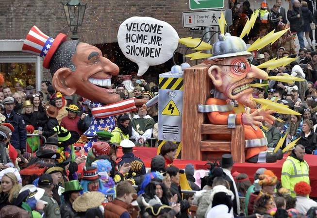 A carnival float depicting US president Barack Obama, left,  putting whistleblower Edward Snowden on an electric chair during the traditional carnival parade in Duesseldorf, western Germany, on Monday, March 3, 2014. The foolish street spectacles in the carnival centers of Duesseldorf, Mainz and Cologne, watched by hundreds of thousands of people, are the highlights in Germany's carnival season on Rose Monday. 