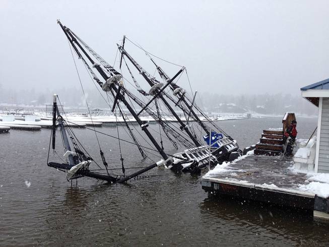 A 43-foot pirate ship tour boat is shown partially submerged in Big Bear Lake, Calif., on Saturday, March 1, 2014. The 27-ton boat had been docked at Holloway Marina before sinking. 