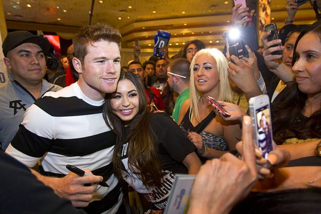 Light middleweight boxer Canelo Alvarez of Mexico poses with a fan in the MGM Grand lobby Tuesday, March 4, 2014. Alvarez will face Alfredo Angulo, also of Mexico, in a non-title, 12-round fight at the MGM Grand Garden Arena on Saturday.