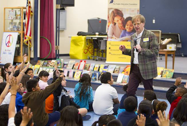 Comedy-magician Mac King looks for volunteers to help him with a trick as he kicks off his Magical Literacy Tour: Nevada Reading Week 2014 with students at Vegas Verdes Elementary School Tuesday, March 4, 2014. For the fourth year, the Harrahs headliner will visit schools to perform magic tricks, talk about the importance of reading and distribute books collected during book drives.