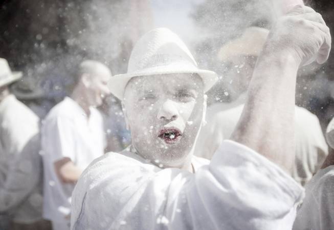 Revellers known as 'Los Indianos', throw talcum powder over each other during carnival in Santa Cruz de la Palma in the Canary islands, Spain Monday March 3, 2014. 'Los 'Indianos' represent the return of emigrants from the Americas, who returned to the island wealthier. (AP Photo/Andres Gutierrez)