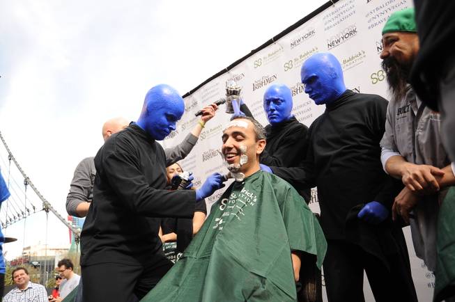 Monte Carlo headliners Blue Man Group shave the head of Shadi Omeish, VP of hotel operations at Monte Carlo, at the St. Baldrick’s Foundation’s fundraiser for childhood cancer research Saturday, March 1, 2014, at New York-New York’s Brooklyn Bridge.

