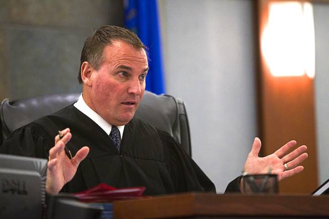 Judge William "Bill" Kephart  questions defense attorney Abel Yanez during in court at the Regional Justice Center Wednesday, March 5, 2014. Yanez is representing former Metro Police Officer Peter Connell. Connell is facing charges of soliciting prostitution.
