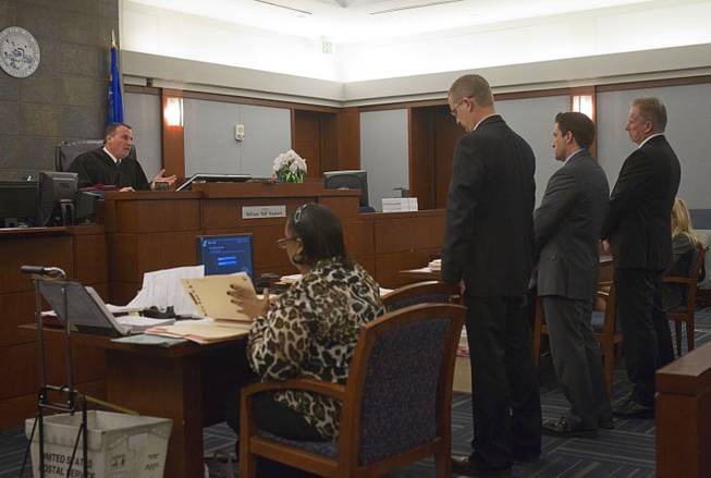 Judge William "Bill" Kephart  questions attorneys as former Metro Police Officer Peter Connell, far right, appears in court at the Regional Justice Center Wednesday, March 5, 2014. Connell is facing charges of soliciting prostitution. Attorneys are Mark Schifalacqua, standing left, and Abel Yanez.