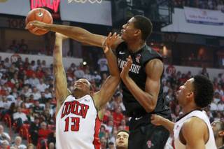 UNLV guard Bryce Dejean Jones has his shot blocked by San Diego State forward Skylar Spencer during their Mountain West Conference game Wednesday, March 5, 2014.